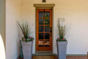 View of exterior entry featuring stucco siding