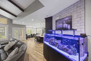 Bar area with light wood-style flooring, recessed lighting, and french doors