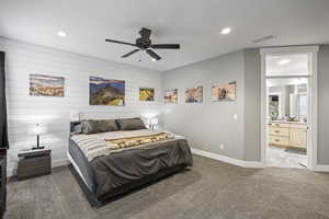 Bedroom with light carpet, baseboards, recessed lighting, ensuite bath, and a ceiling fan