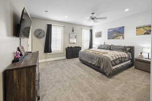 Carpeted bedroom featuring baseboards, ceiling fan, and recessed lighting