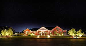 View of front of property.. Yard lights on a timer and eave lights on home