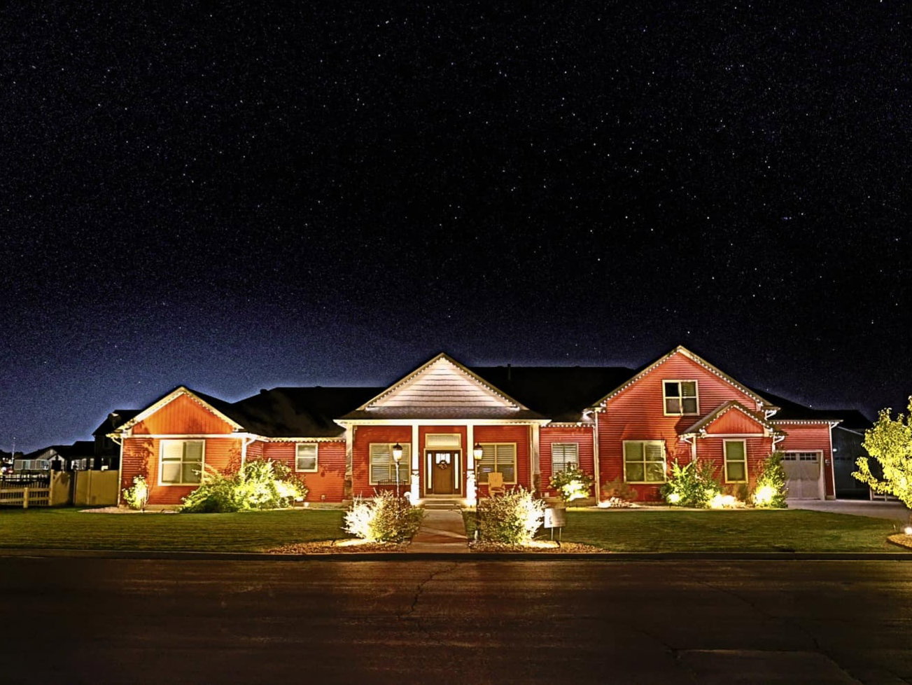 View of front of property.. Yard lights on a timer and eave lights on home