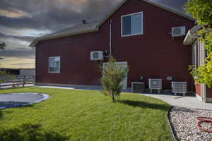 View of property exterior with central AC, a trampoline, and a cooling unit