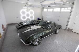 new epoxy floor in  main garage with hexagon lights on walls and ceiling.