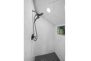 Bathroom featuring a tile shower