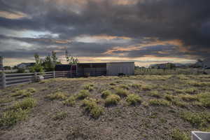 View of yard with an outdoor structure and a pole building