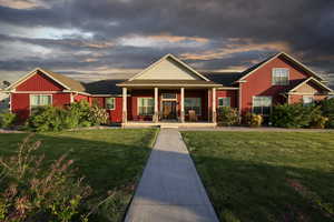 Craftsman house with a porch, a yard, and roof with shingles