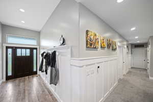 Entryway featuring recessed lighting and a wainscoted wall