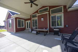View of patio featuring entry steps, a ceiling fan, area for grilling, and french doors