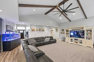 Living room featuring wood finished floors, ceiling fan, high vaulted ceiling, recessed lighting, and wood ceiling with exposed beams