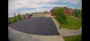 View of back area asphalt driveway featuring a residential view