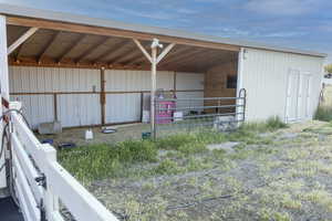 View of outdoor stables with water and power / storage room.