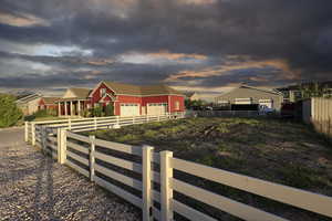 View of front of house with a residential view, an outbuilding, and a pole building