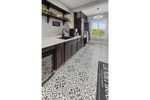 laundry room with tile patterned floors and baseboards