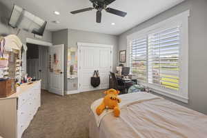 Bedroom with carpet, recessed lighting, a ceiling fan, a closet, and an office area