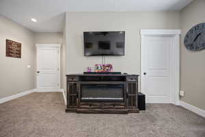 Carpeted living room featuring baseboards