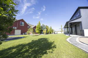 View of grassy yard featuring a garage