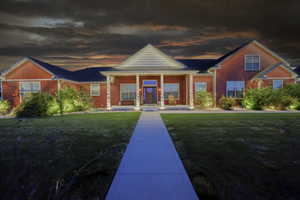 View of front of property featuring covered porch and a front lawn