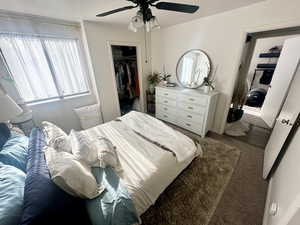 Carpeted bedroom with a closet and ceiling fan