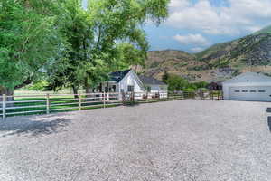 View of front facade with a garage, a mountain view, and an outdoor structure