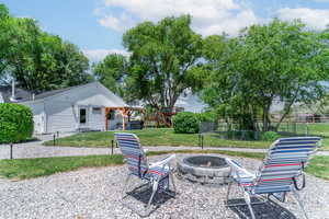View of patio with a fire pit