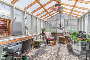 Sunroom / solarium featuring vaulted ceiling