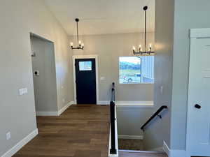 Entrance foyer with chandeliers and cast iron railing