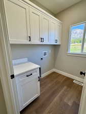 Laundry area featuring cabinet space, quartz countertop, washer hookup, and electric dryer hookup
