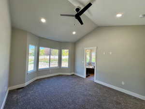 Master bedroom with vaulted ceiling and ceiling fan