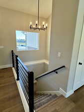Stairway with chandelier and cast iron railing