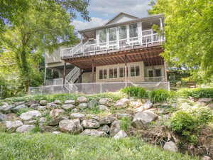 Back of property featuring a deck and stairway