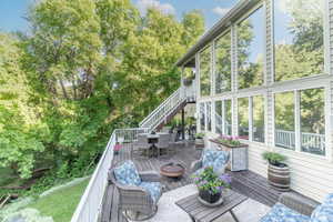 Wooden deck featuring outdoor dining area and stairway