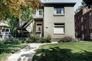 View of front of property featuring brick siding and a front yard