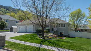 View of front of home featuring concrete driveway, a 2 car garage, stucco siding, a mountain view
