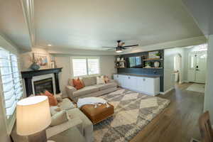 Living area also includes a beautifully styled built-in. Lovely black ship lap accent wall and storage below!