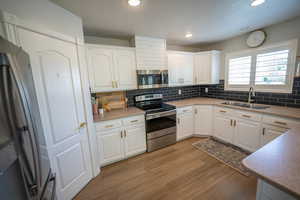 Beautiful white cabinetry with gold hardware.
