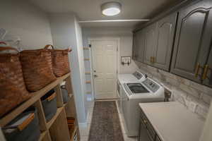 Laundry room is equipped with plenty of storage/cabinet space, counter space and new marble backsplash!