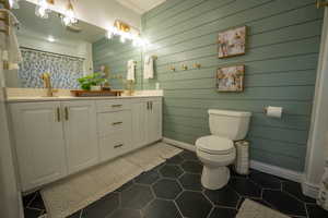 Master Bathroom is flanked by his and hers closets.  The shiplap walls give this roomy space a style upgrade!