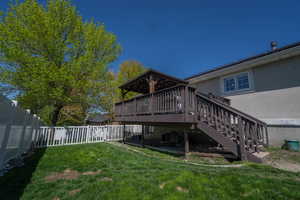 View of yard featuring stairs and a deck
