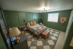 Bedroom 5 featuring a decorative wall, moody paint and updated in all the right ways!