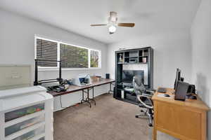 Office area featuring a ceiling fan and carpet floors