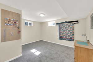Basement featuring carpet floors and baseboards