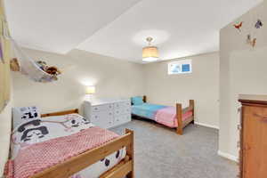 Bedroom with light carpet and baseboards
