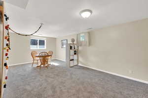 Dining space with carpet floors and baseboards
