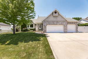 View of front facade featuring a garage, concrete driveway, stucco siding, roof with shingles, and a gate