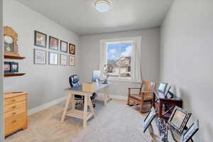Home office with carpet flooring and baseboards