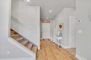 Entrance foyer with stairway, recessed lighting, light wood finished floors, and baseboards