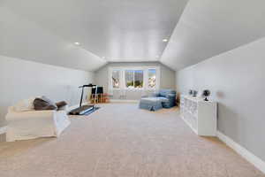 Sitting room with carpet, vaulted ceiling, baseboards, a textured ceiling, and recessed lighting