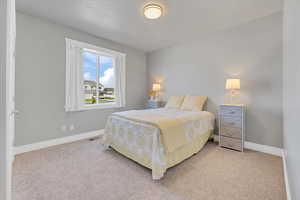 Carpeted bedroom featuring baseboards