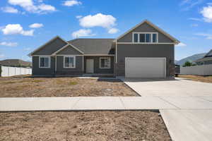 Craftsman-style house featuring driveway, a garage, and a shingled roof